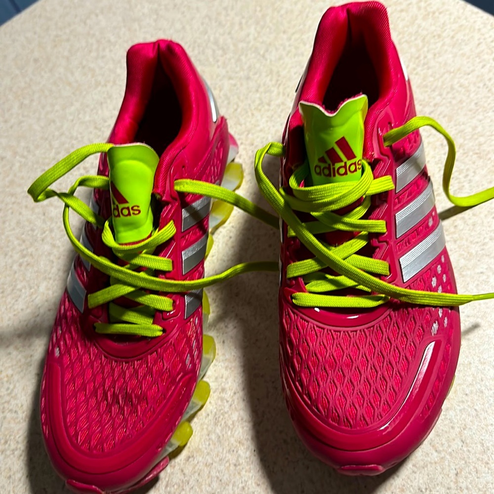 Pink and green adidas spring blade sneakers.